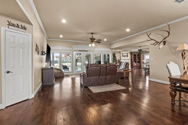 a living room with furniture and a wooden floor