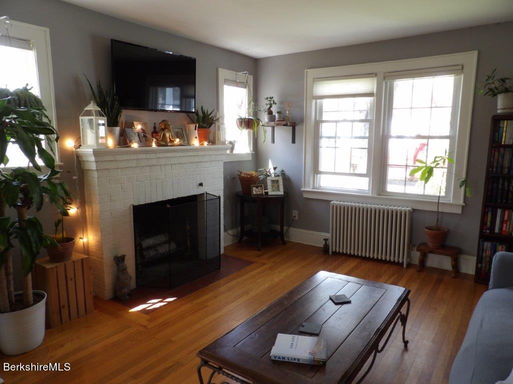 64 Cleveland Street Pittsfield, MA 01201 - Photo 13 of 32 a living room with furniture fireplace and flat screen tv