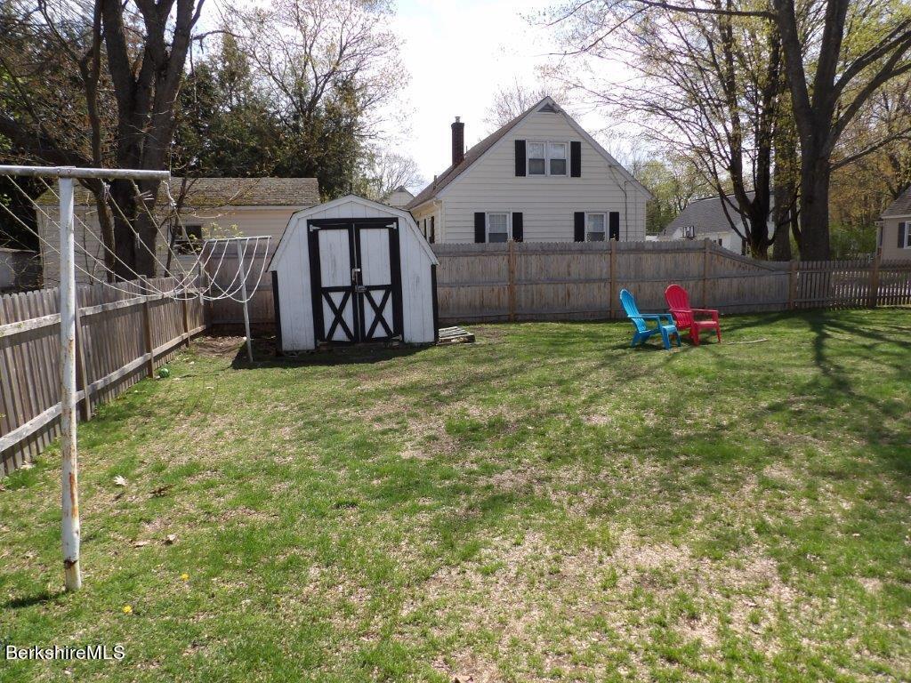 64 Cleveland Street Pittsfield, MA 01201 - Photo 30 of 32 a view of backyard with wooden fence and large trees