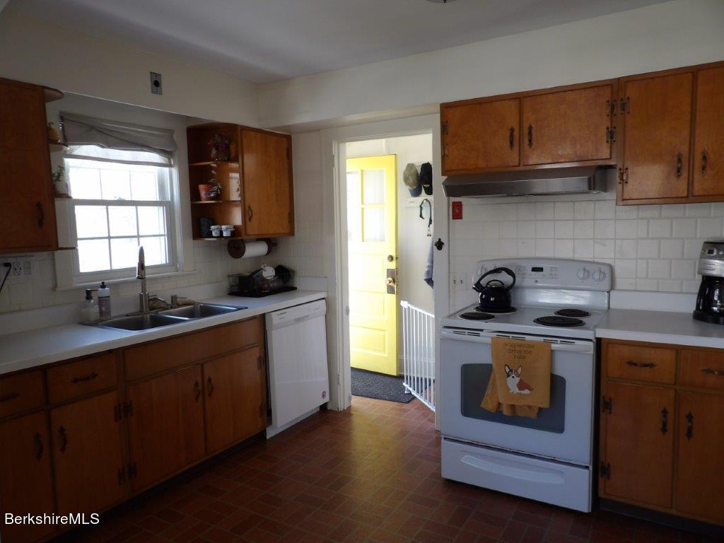 64 Cleveland Street Pittsfield, MA 01201 - Photo 4 of 32 a kitchen with a stove a sink and a microwave