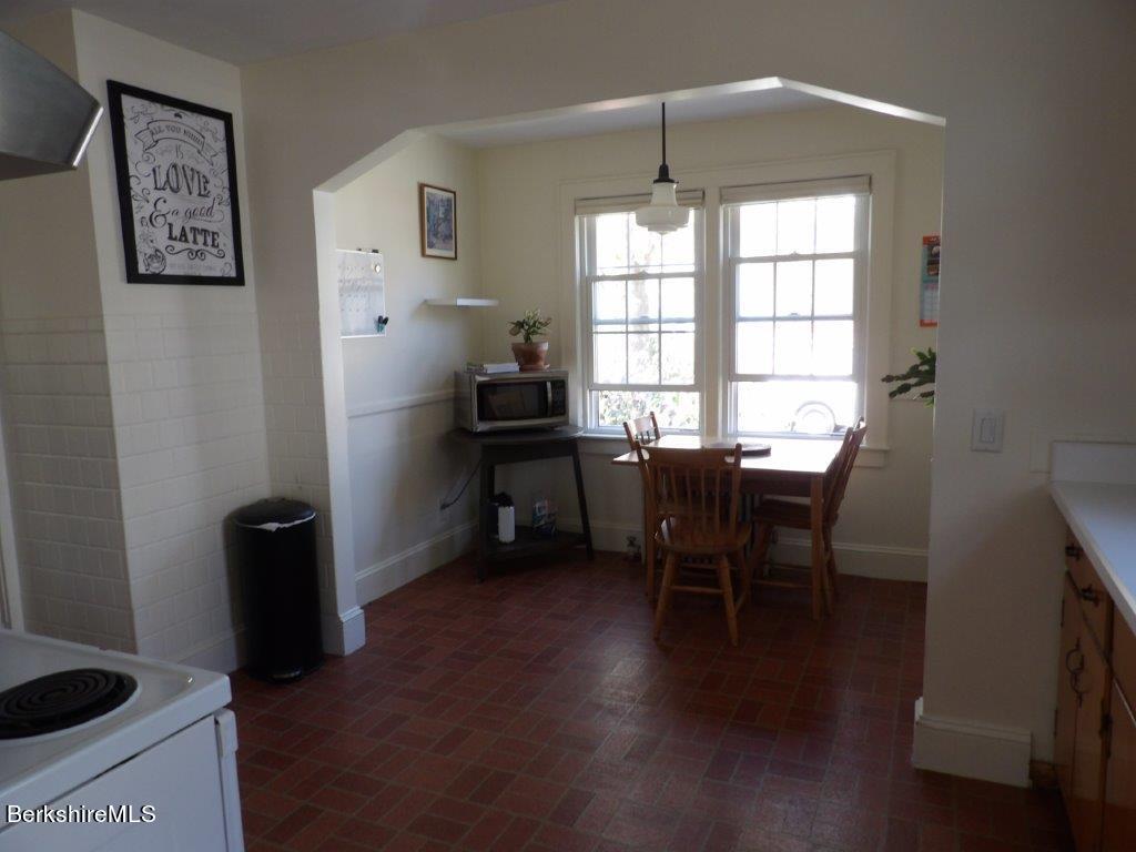 64 Cleveland Street Pittsfield, MA 01201 - Photo 5 of 32 a view of a workspace with furniture and a window