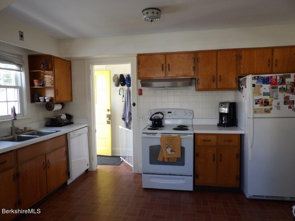 64 Cleveland Street Pittsfield, MA 01201 - Photo 6 of 32 a kitchen with stainless steel appliances granite countertop a stove a sink dishwasher and a refrigerator
