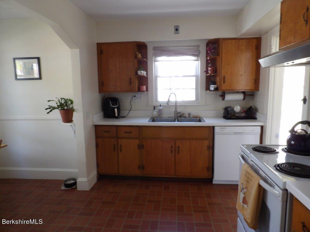 64 Cleveland Street Pittsfield, MA 01201 - Photo 7 of 32 a kitchen with a sink cabinets and a window
