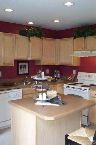 3637 Bison Hill Lane Raleigh, NC 27604 - Photo 2 of 10 a kitchen with kitchen island granite countertop a sink and a stove top oven