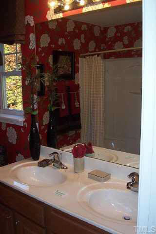 3637 Bison Hill Lane Raleigh, NC 27604 - Photo 4 of 10 a bathroom with a sink and a mirror