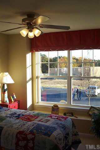 3637 Bison Hill Lane Raleigh, NC 27604 - Photo 7 of 10 a bedroom with a bed and a large window