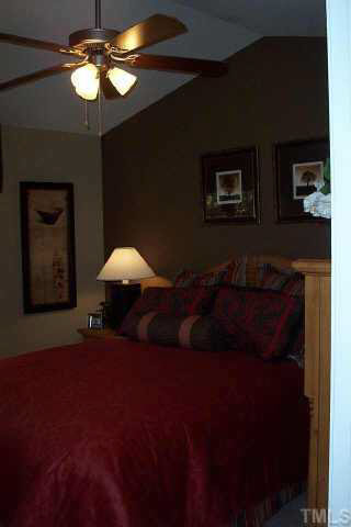 3637 Bison Hill Lane Raleigh, NC 27604 - Photo 8 of 10 a bed room with a bed and a lamp