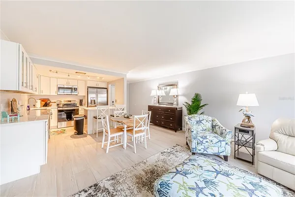 a living room with furniture large window and a table
