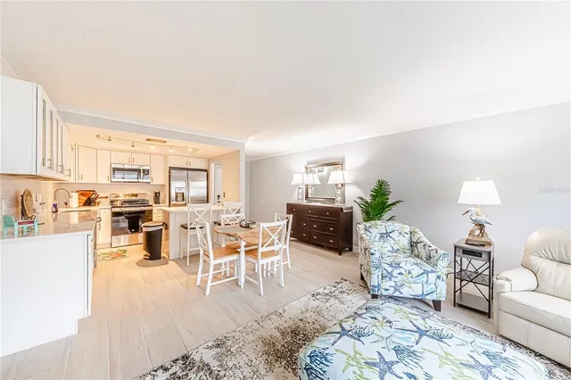 a living room with furniture large window and a table