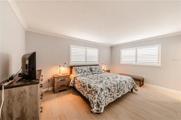 a bedroom with a bed a couch and a window