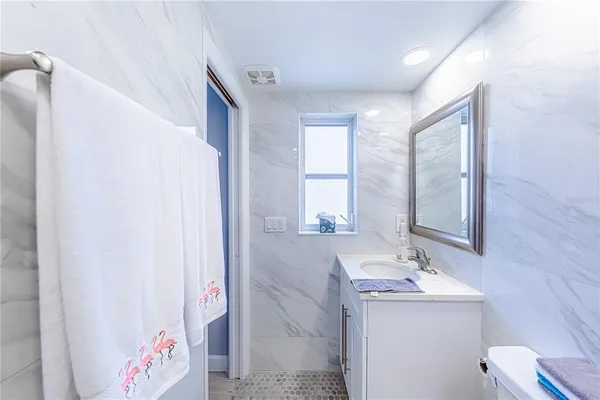 a bathroom with a sink double vanity and a mirror