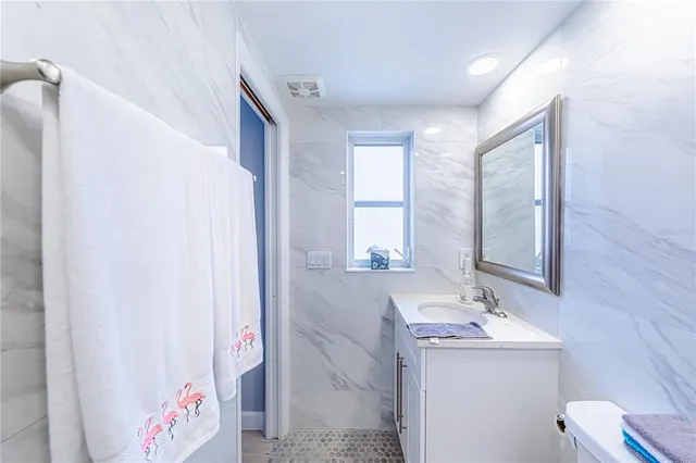 a bathroom with a sink double vanity and a mirror