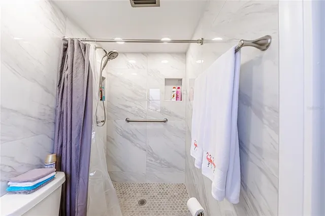 a bathroom with a shower and a glass door