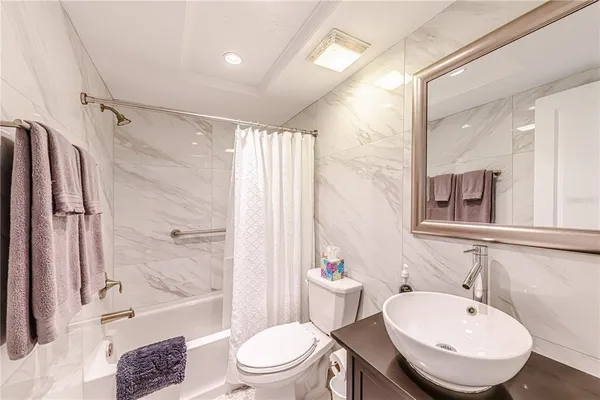 a bathroom with a bathtub toilet sink and shower