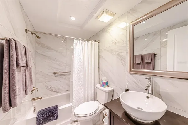 a bathroom with a bathtub toilet sink and shower