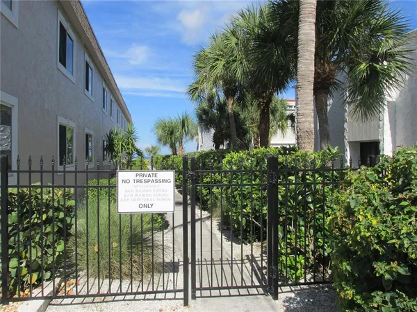 a view of a house with a tree and a yard