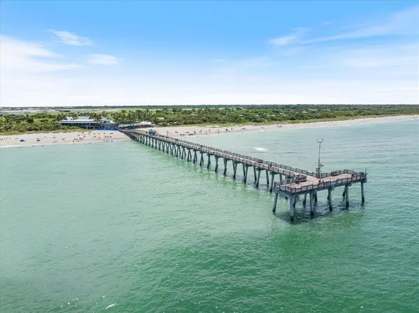 a view of a lake with table and chairs