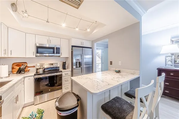 a kitchen with a stove a sink and a refrigerator