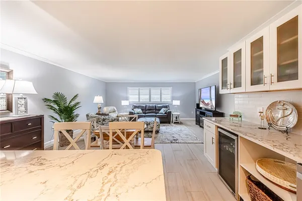 a view of a kitchen with sink and cabinets