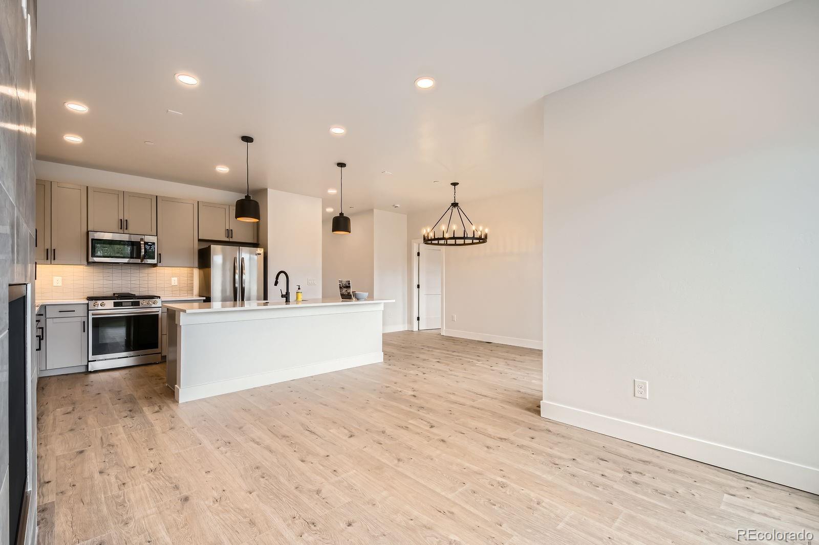 1501 James Drive Tabernash, CO 80478 - Photo 4 of 25 a large kitchen with stainless steel appliances kitchen island granite countertop a large counter top and a stove top oven