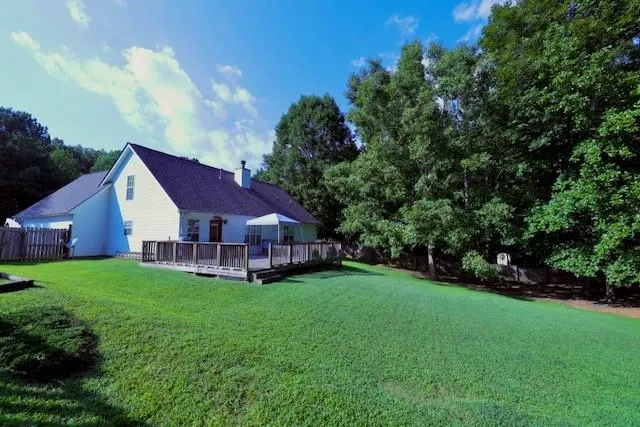 a view of a house with a yard and sitting area