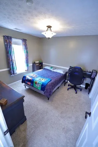 a bedroom with a bed and window