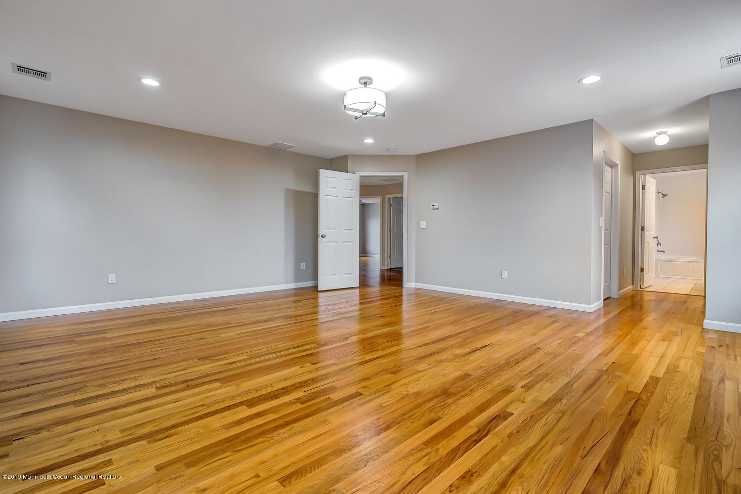 14 Stuyvesant Road Brick, NJ 08723 - Photo 20 of 32 a view of an empty room with wooden floor and a kitchen