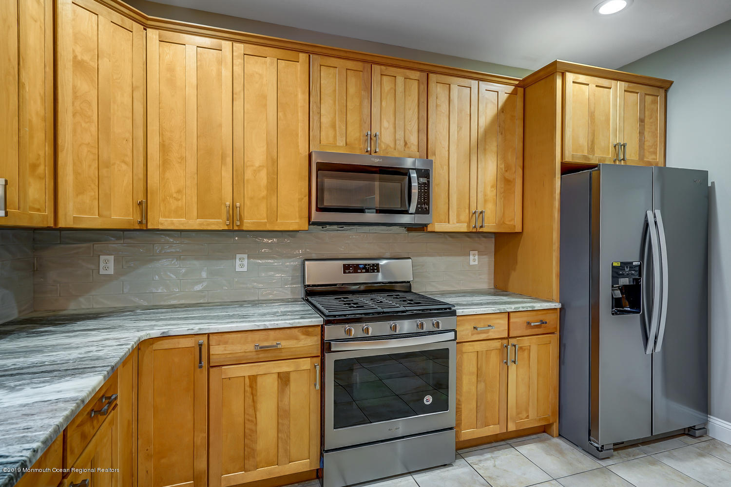 14 Stuyvesant Road Brick, NJ 08723 - Photo 5 of 32 a kitchen with granite countertop a stove top oven microwave and refrigerator