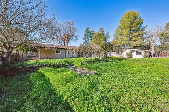 a view of a house with a backyard