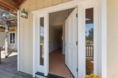 a view of a hallway with wooden floor and entryway