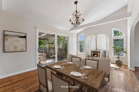 a view of a dining room with furniture a chandelier and wooden floor