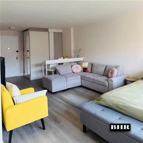 a living room with furniture and a night stand