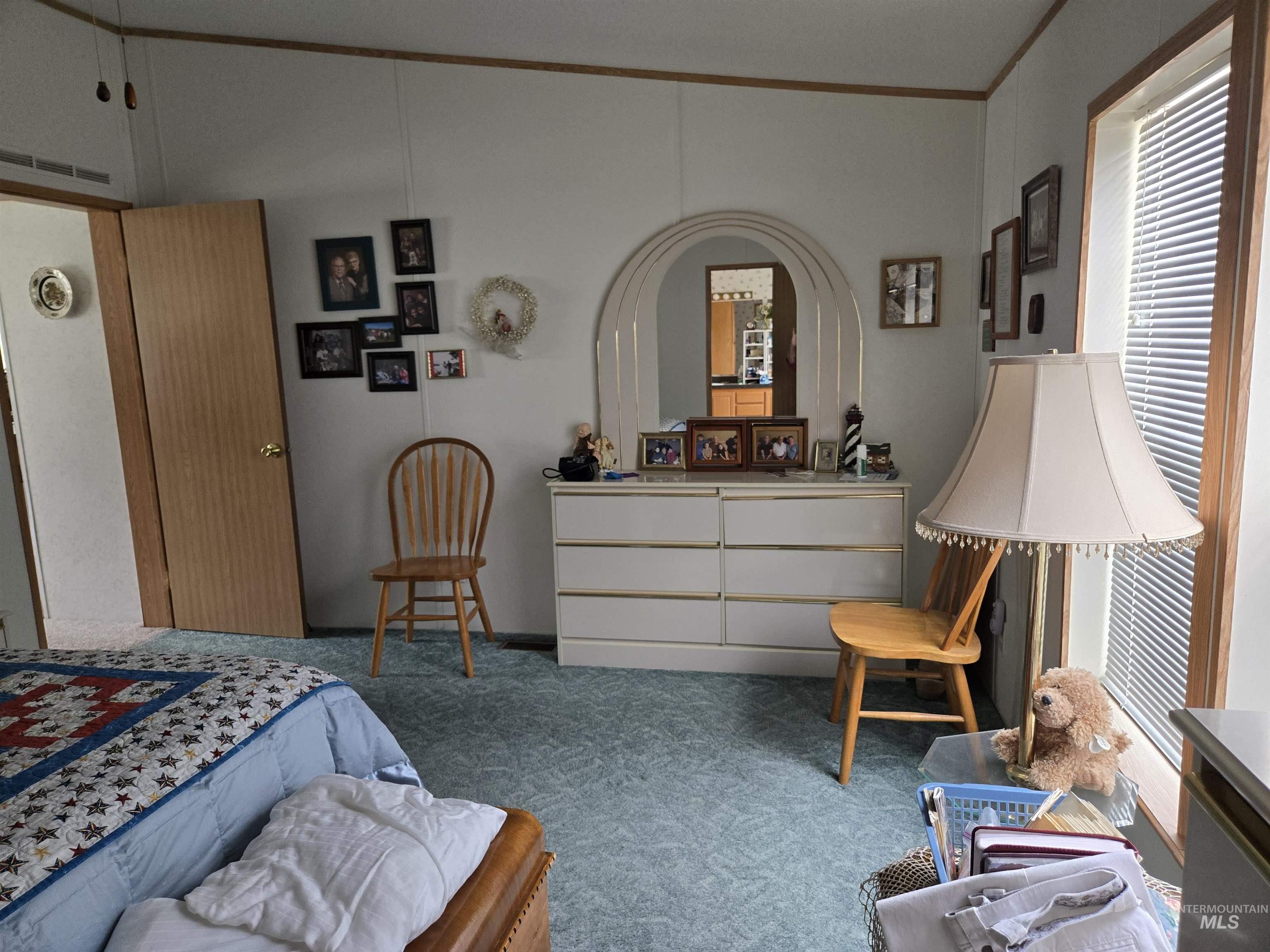 2750 Alden Road, Unit 37 Fruitland, ID 83619 - Photo 16 of 30 Bedroom with carpet, ornamental molding, and multiple windows