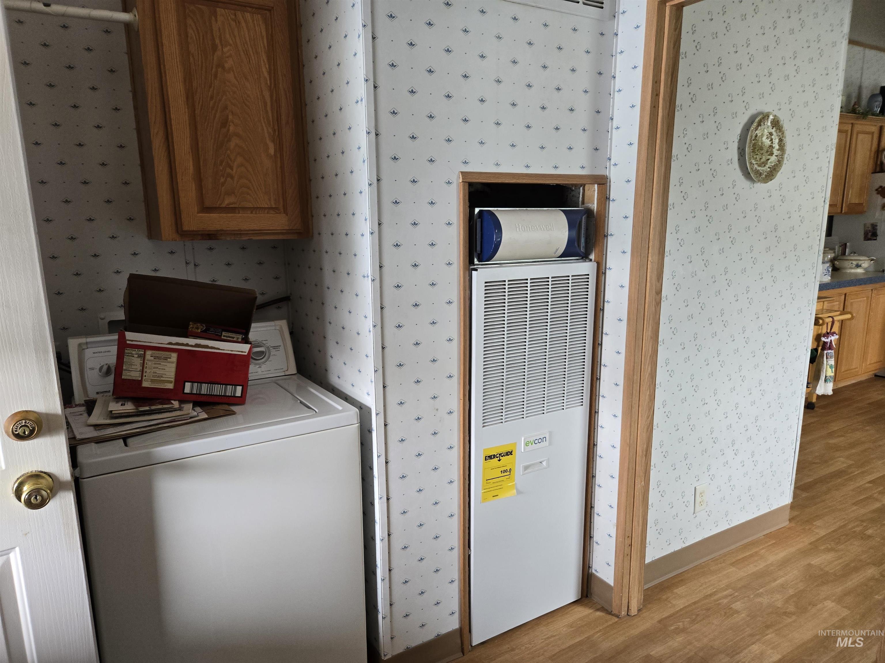 2750 Alden Road, Unit 37 Fruitland, ID 83619 - Photo 26 of 30 Washroom with wallpapered walls, washer / dryer, light wood finished floors, and a heating unit