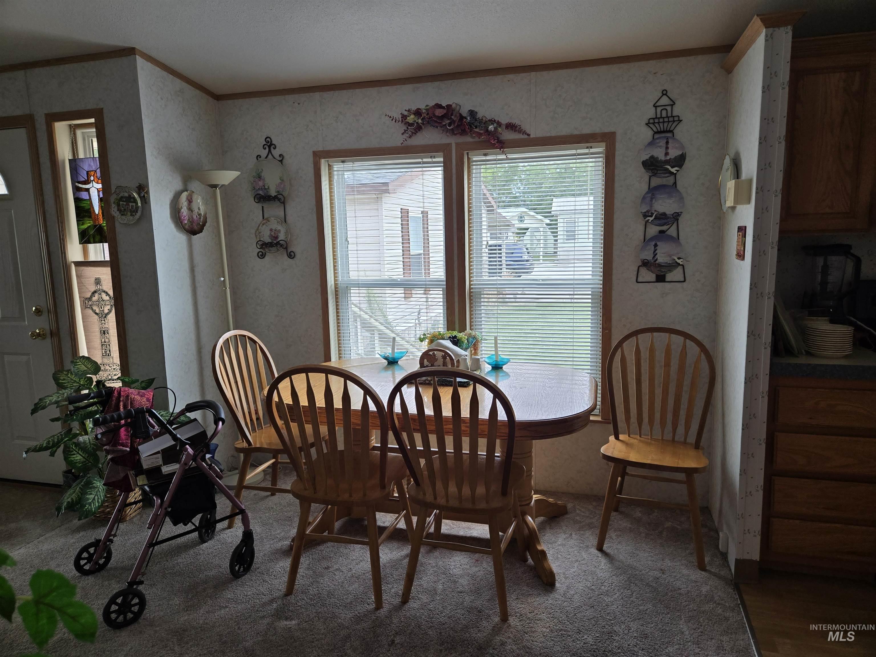 2750 Alden Road, Unit 37 Fruitland, ID 83619 - Photo 9 of 30 Dining room with crown molding, wallpapered walls, and carpet flooring
