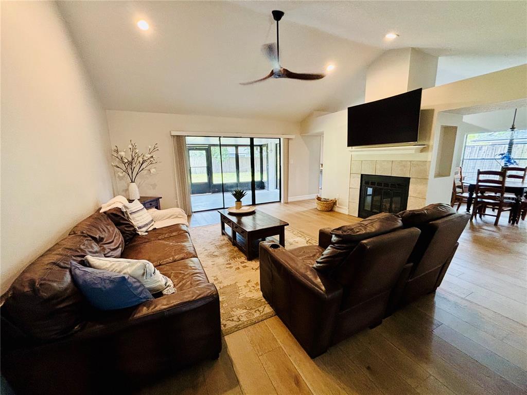 1045 Shaffer Trail Oviedo, FL 32765 - Photo 4 of 30 a living room with furniture fireplace and a flat screen tv