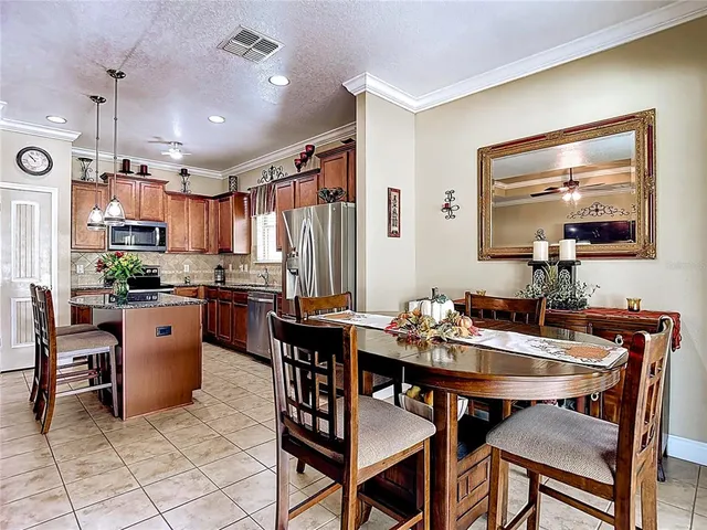 a kitchen with stainless steel appliances granite countertop a stove microwave and cabinets