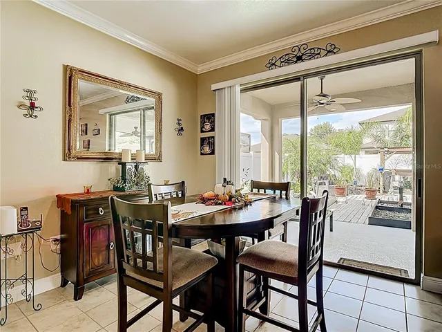 a kitchen with granite countertop kitchen island a table and chairs in it
