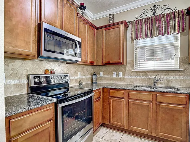 a bathroom with a granite countertop sink a large mirror and vanity