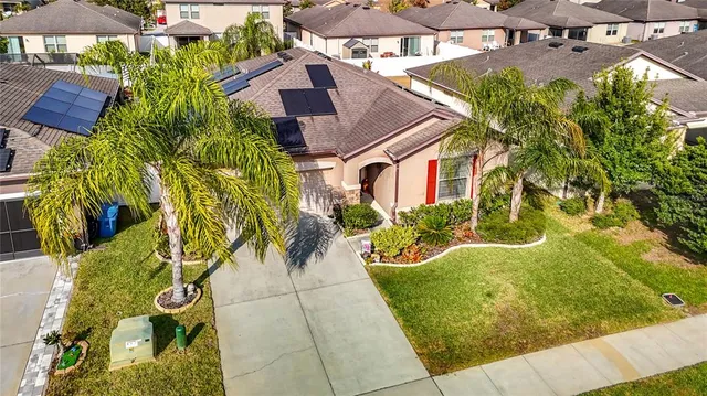 a front view of a house with a yard garage and outdoor seating