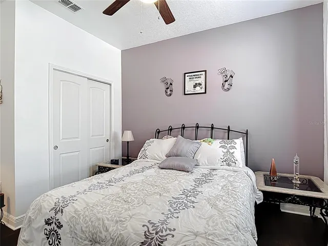 a bathroom with a granite countertop sink vanity mirror bathtub and toilet