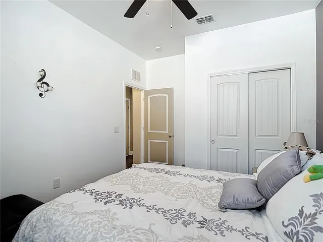 a bedroom with a bed and a painting on the wall