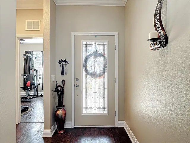 a living room with furniture kitchen view and a wooden floor