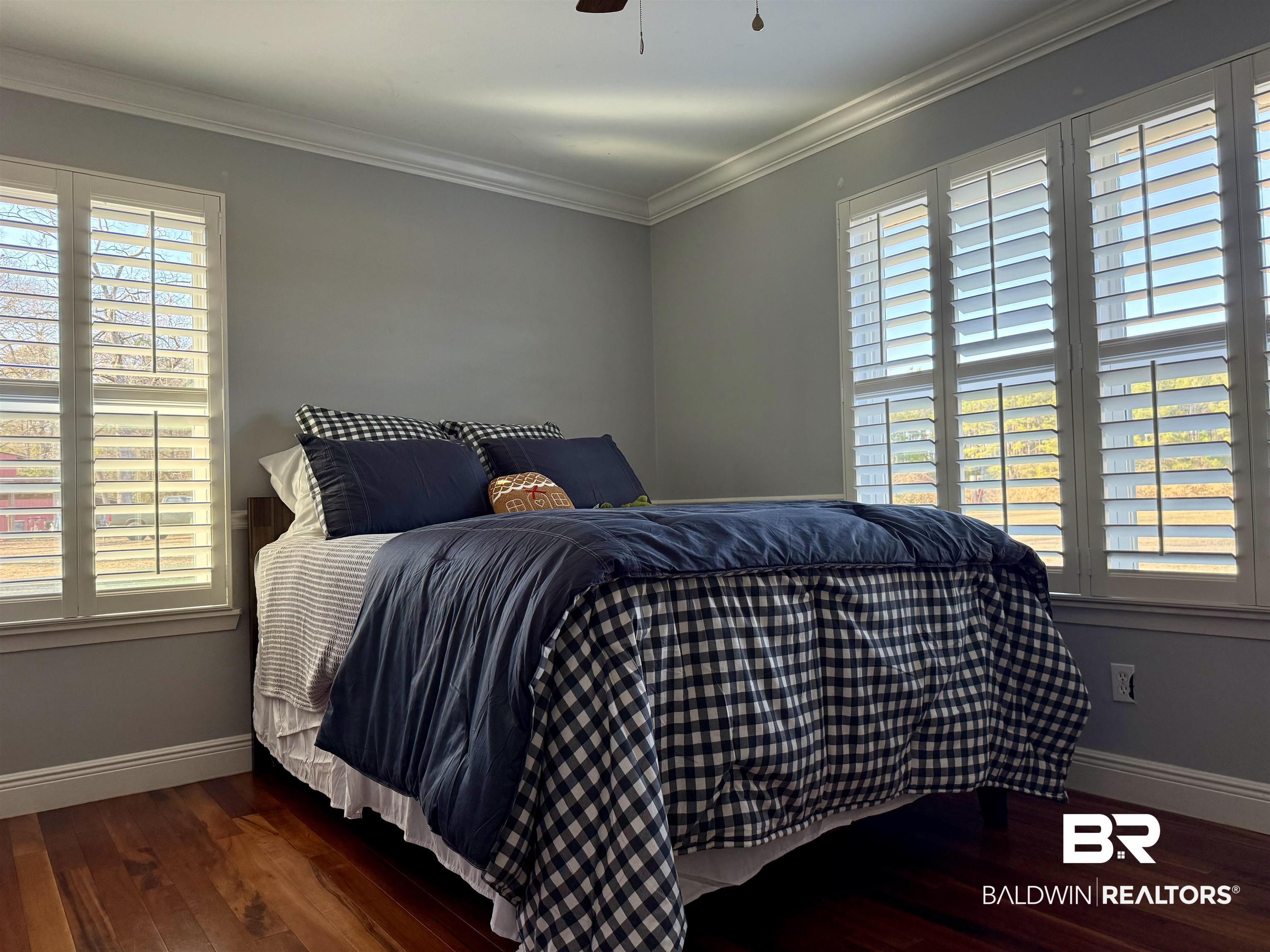 5646 Foshee Road Brewton, AL 36426 - Photo 22 of 37 Bedroom featuring dark wood-type flooring, crown molding, multiple windows, and a ceiling fan