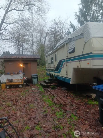 a backyard of a house with barbeque oven