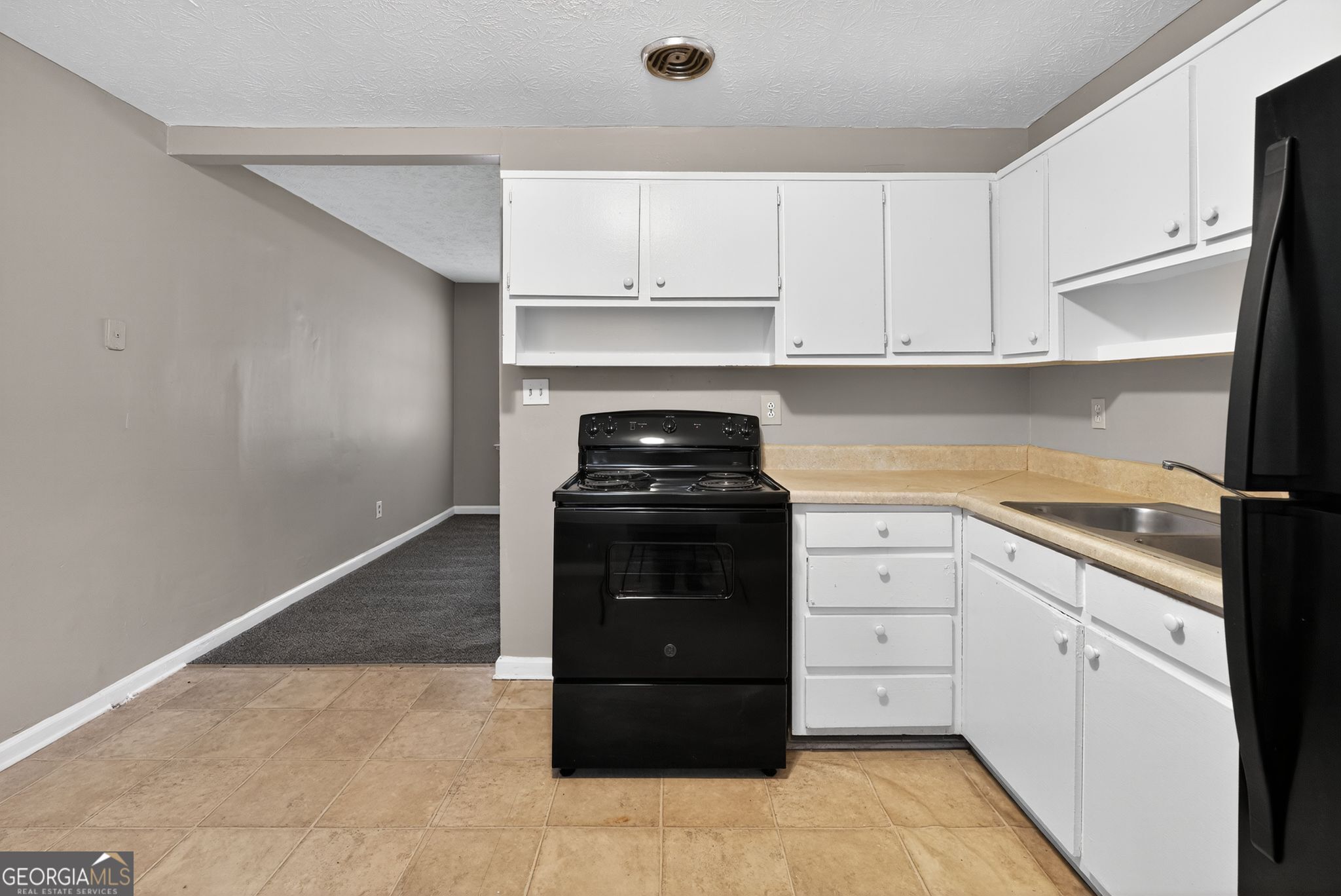 8207 Dunellen Lane Jonesboro, GA 30238 - Photo 15 of 33 a kitchen with a stove and a refrigerator