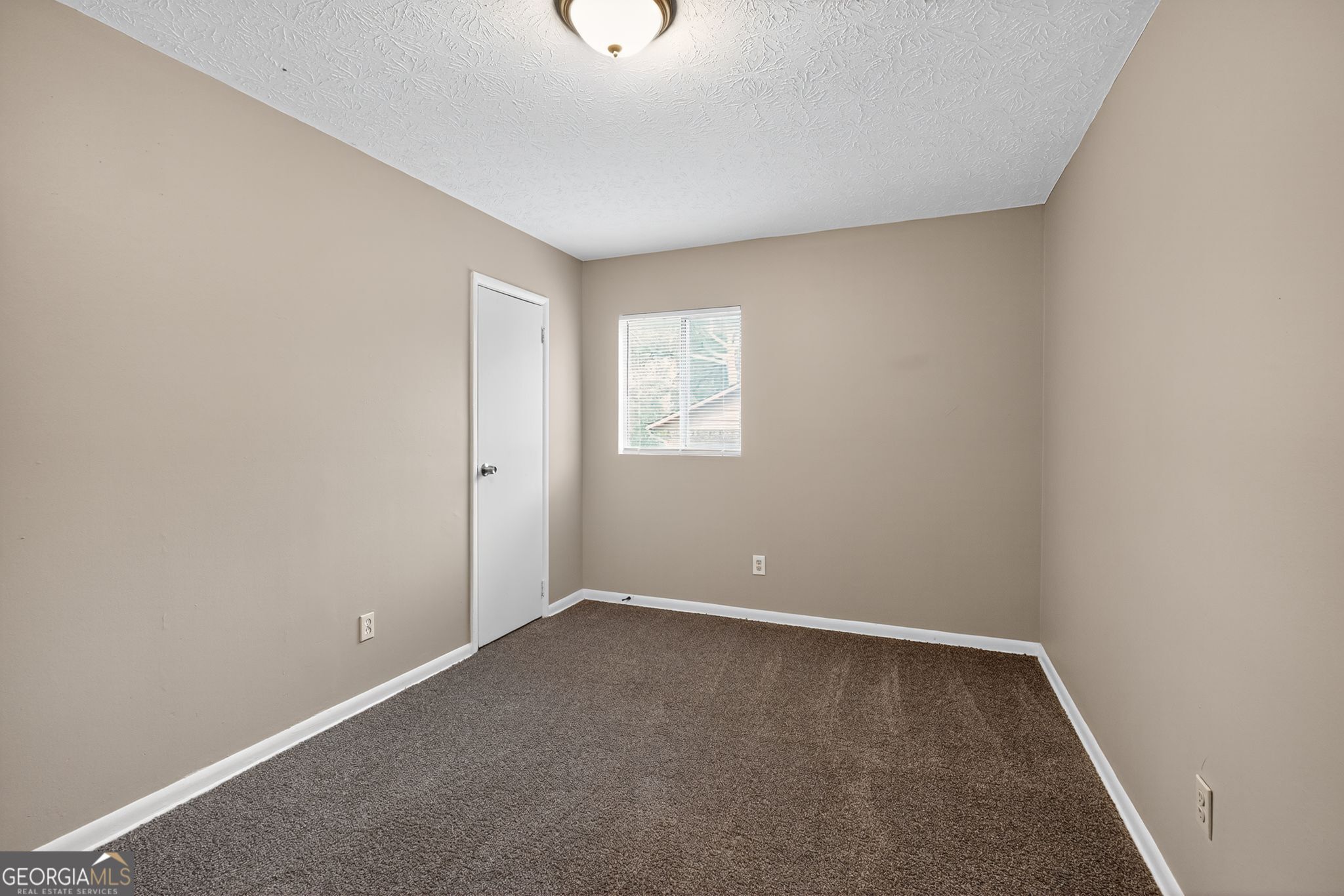 8207 Dunellen Lane Jonesboro, GA 30238 - Photo 19 of 33 an empty room with a window