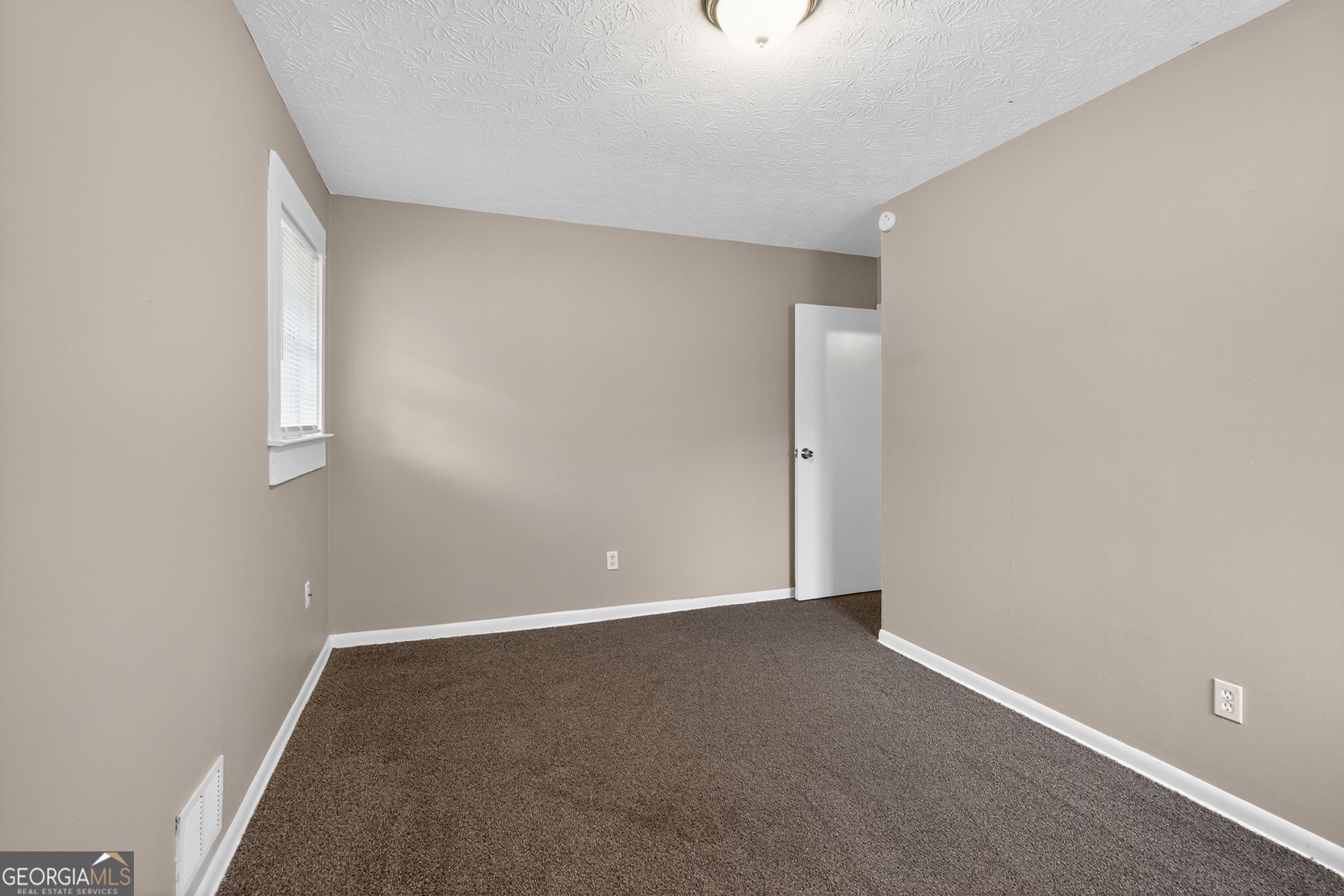 8207 Dunellen Lane Jonesboro, GA 30238 - Photo 21 of 33 a view of an empty room with a window