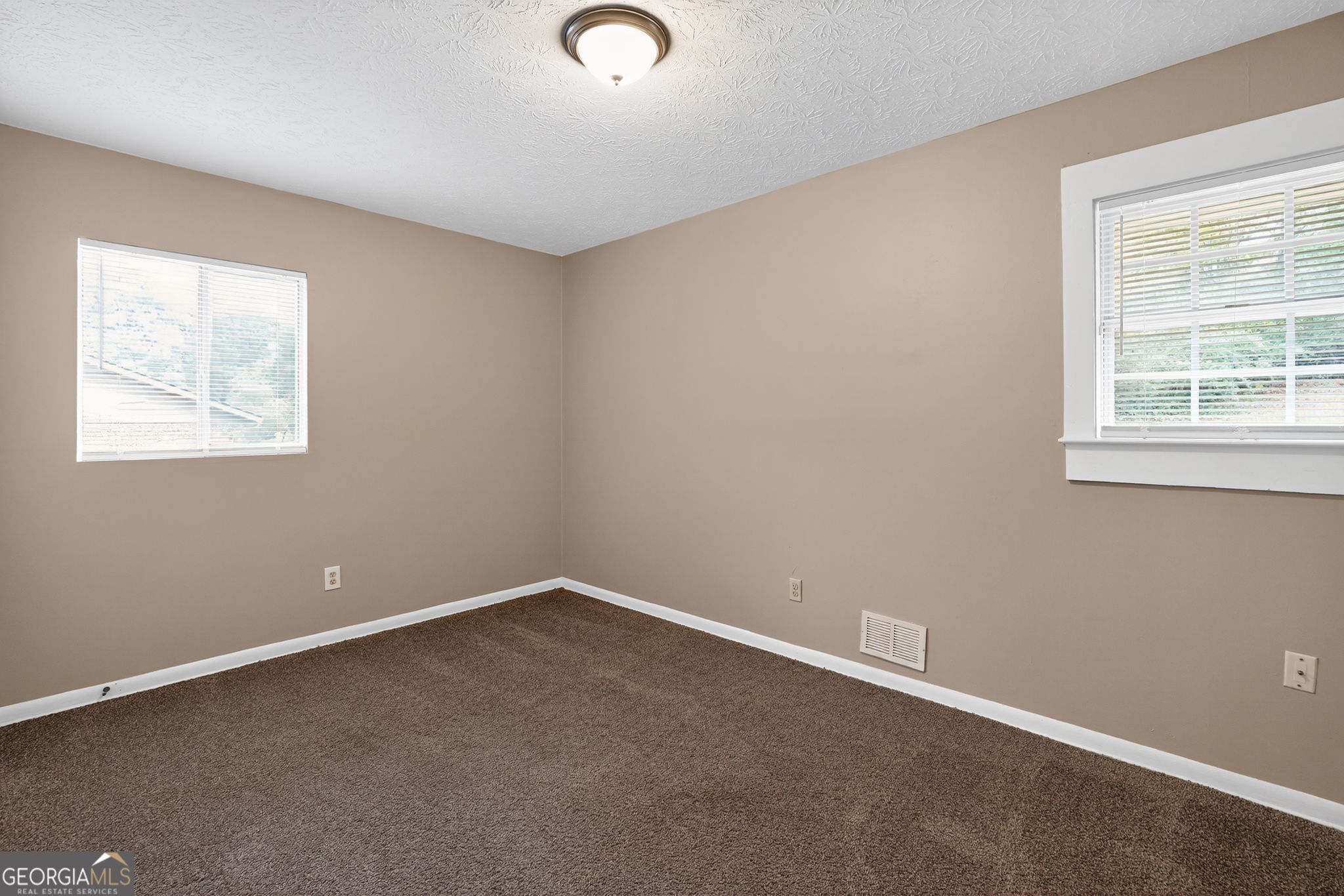 8207 Dunellen Lane Jonesboro, GA 30238 - Photo 22 of 33 an empty room with a window