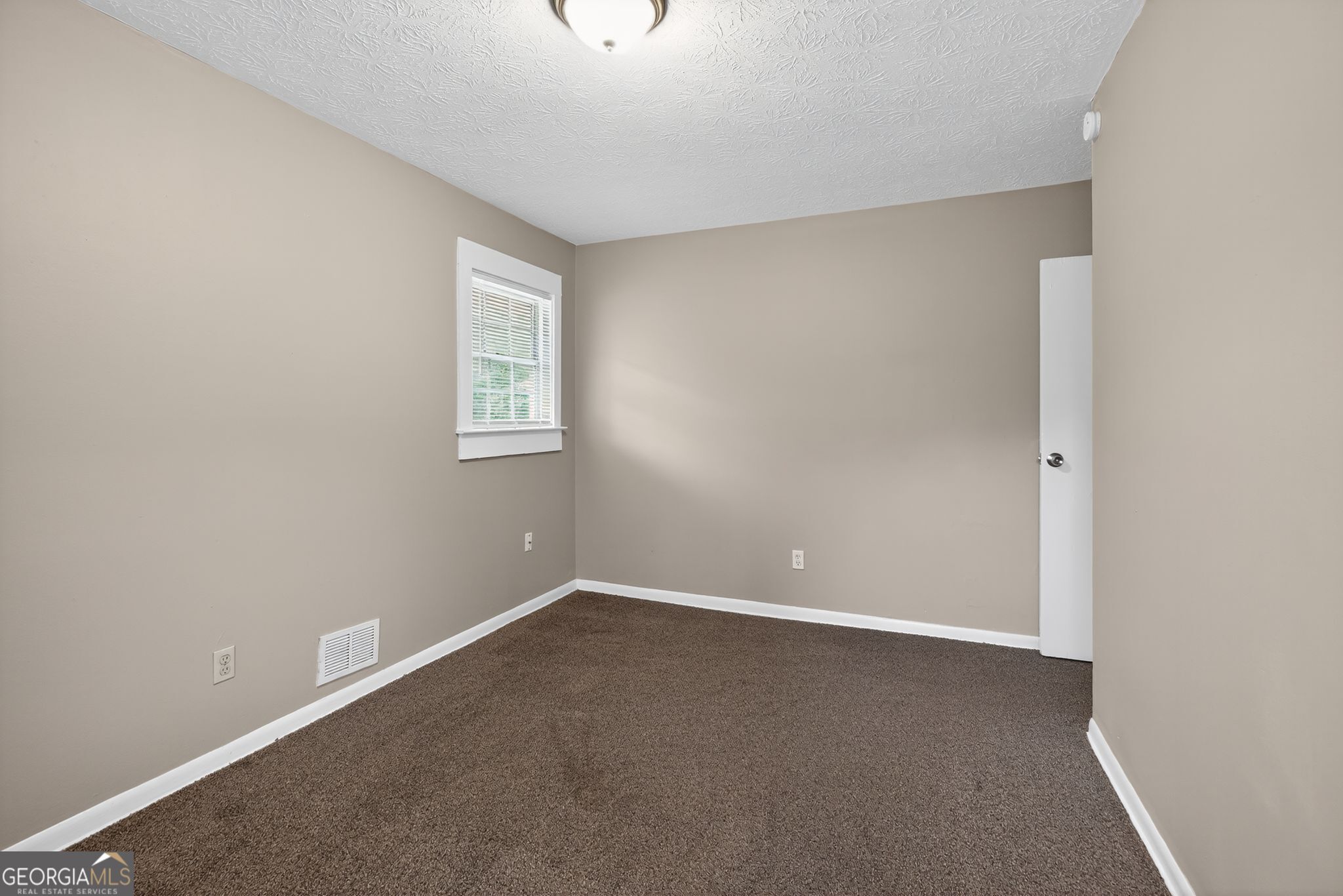 8207 Dunellen Lane Jonesboro, GA 30238 - Photo 25 of 33 an empty room with a window